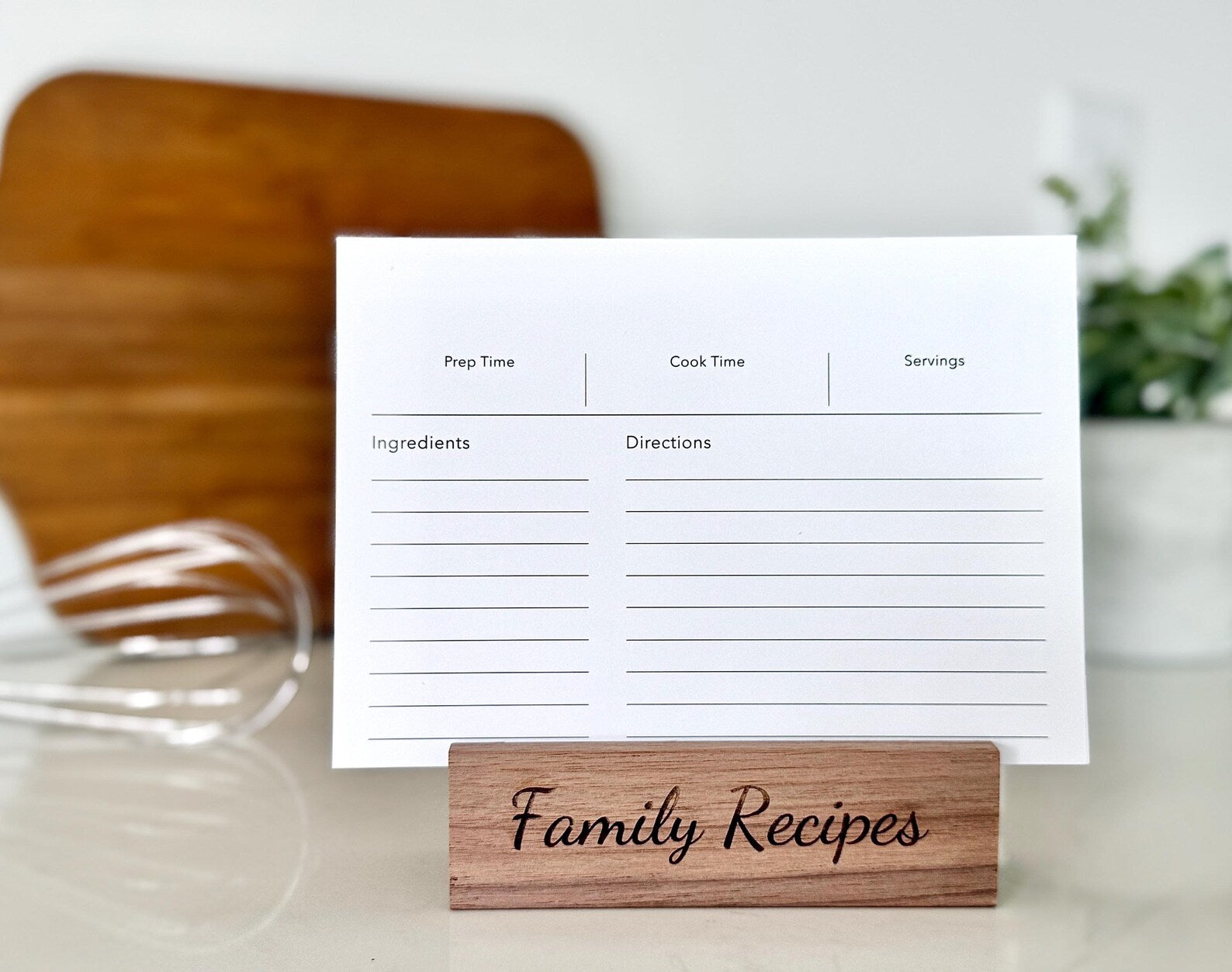 Recipe card with a wooden holder labeled 'Family Recipes' on a kitchen counter.