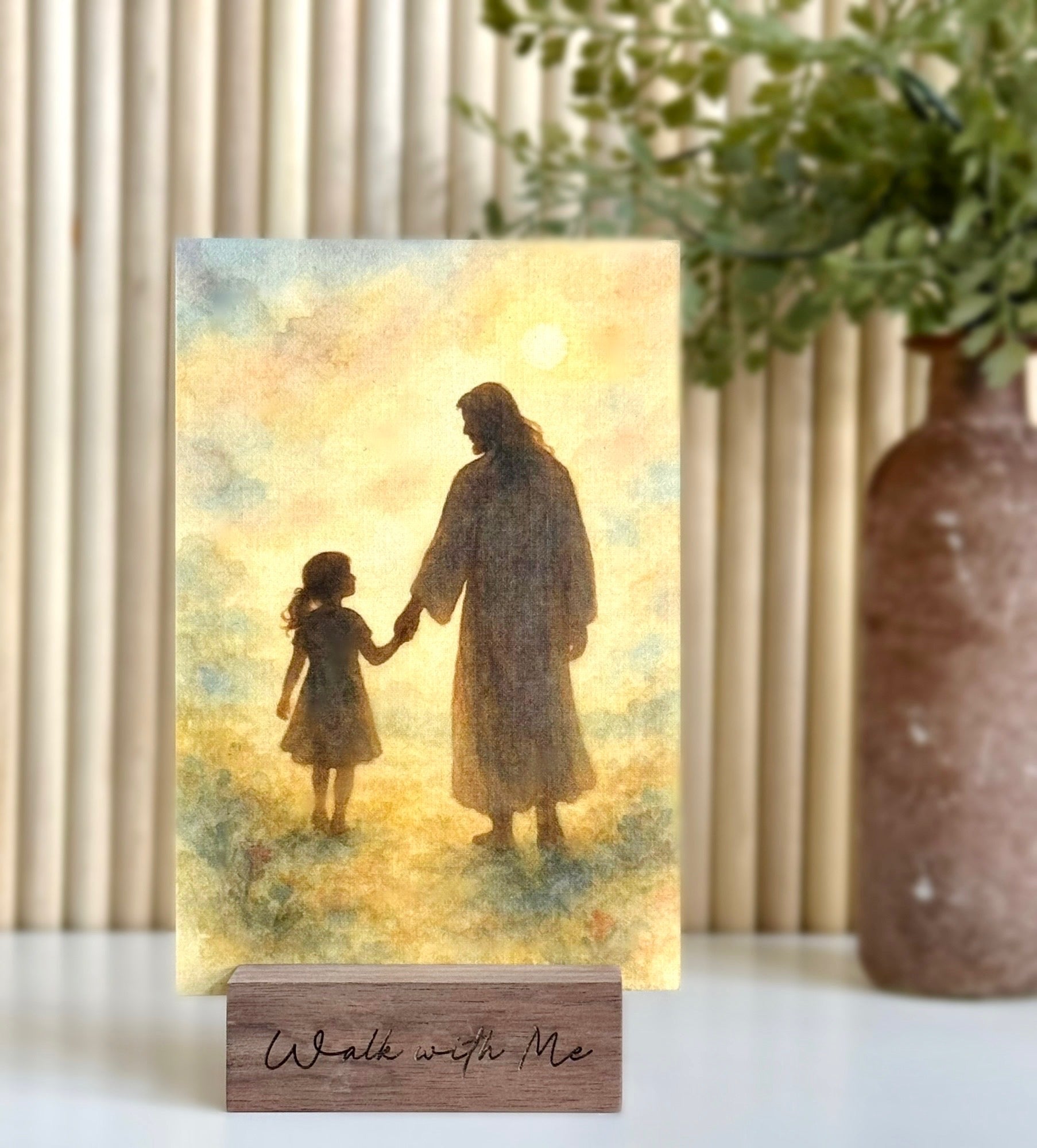 Decorative plaque with silhouette of a man and a child holding hands, placed on a wooden stand with 'Walk with Me' text.