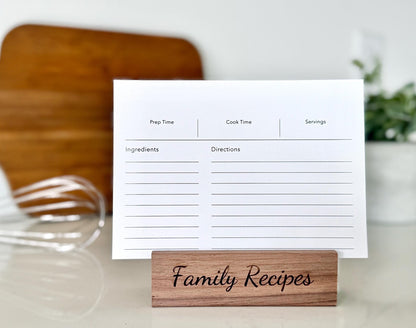 Recipe card with a wooden holder labeled 'Family Recipes' on a kitchen counter.